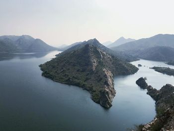 Scenic view of lake and mountains against sky