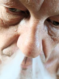 Close-up of man exhaling smoke