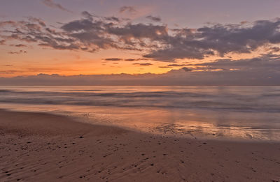 Scenic view of beach against sky during sunset