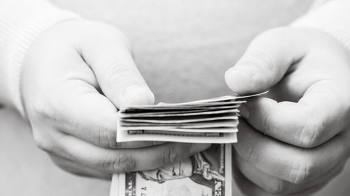 Cropped hand of woman holding paper currency