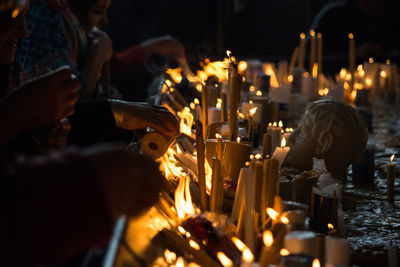 Panoramic view of people holding lit candles