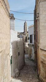 Alley amidst buildings against sky