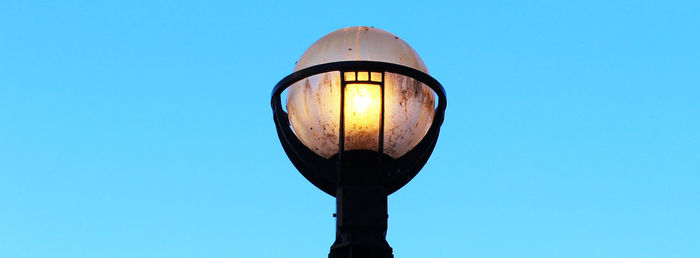 Low angle view of street light against clear blue sky