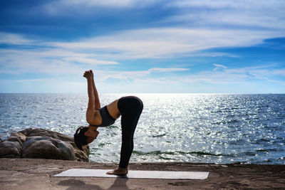 Full length of woman in sea against sky