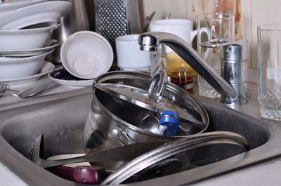 Kitchen utensils in sink at home