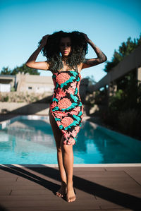 Portrait of woman standing in swimming pool