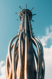 Low angle view of machinery against sky