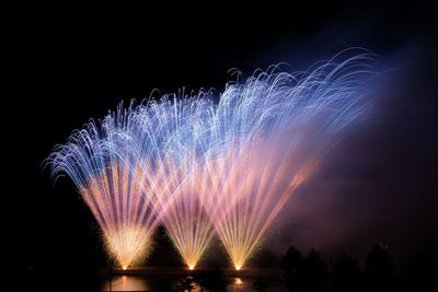 Low angle view of firework display at night