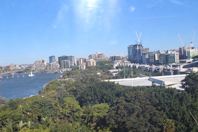 High angle view of cityscape by sea against sky