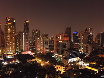 High angle view of illuminated buildings against sky at night