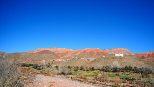 Scenic view of mountains against clear blue sky