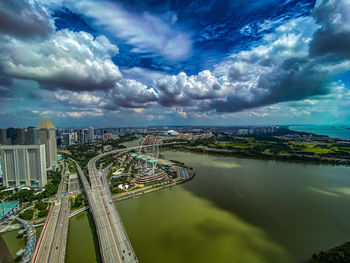 High angle view of river amidst buildings against sky