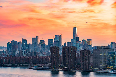 View of buildings against cloudy sky during sunset