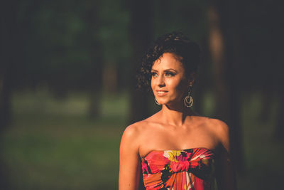 Portrait of beautiful young woman looking away