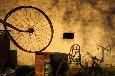 Bicycle parked against wall of old building