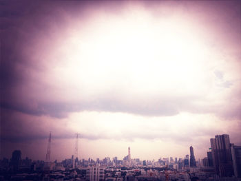 Cityscape against cloudy sky