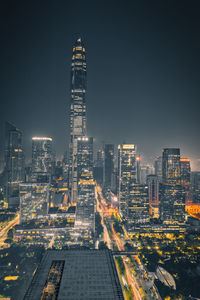 Illuminated buildings in city against sky at night