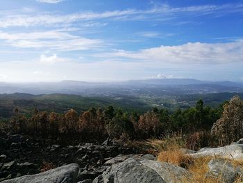 Scenic view of mountains against cloudy sky