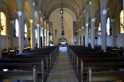 Walkway amidst pew at church