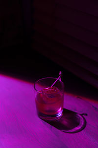 Still life cocktail with bourbon in neon lights