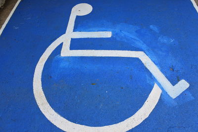 High angle view of wheelchair access sign on parking lot