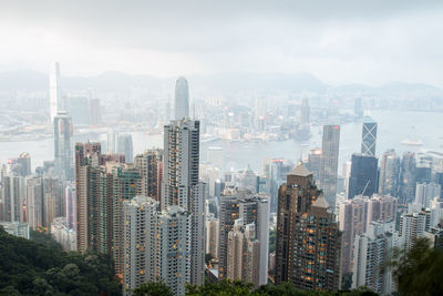 High angle view of modern buildings in city against sky