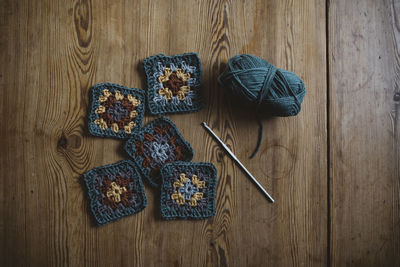 Crochet squares on wooden background