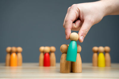 Cropped hand of woman with toy blocks on table