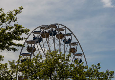 Low angle view of ferris wheel against sky