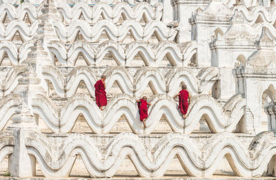 Back side of three young monk are climbing up on the mya thein tan pagoda at bagan, mandala