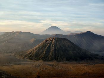 Scenic view of mountains against cloudy sky