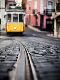 Tram by buildings in city