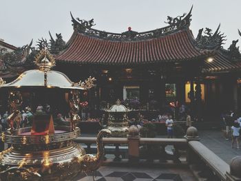 People in temple against sky