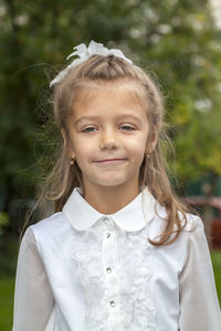 Portrait of smiling girl standing outdoors