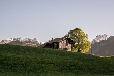 House on mountain against clear sky