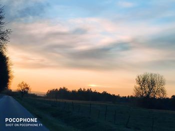 Scenic view of field against sky during sunset