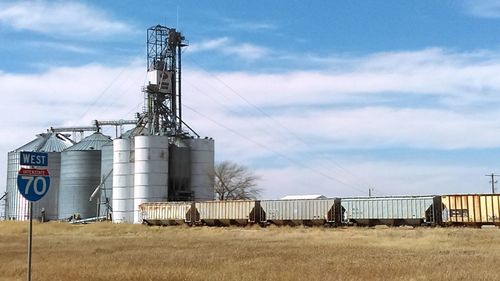 Metallic structure on field against sky