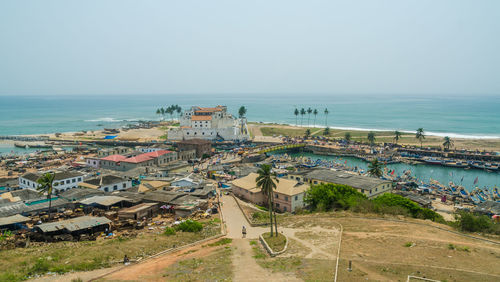 High angle view of town by sea against clear sky