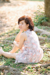 Young woman sitting on field