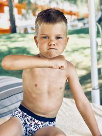 Portrait of shirtless boy in swimming pool