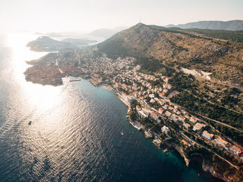 High angle view of buildings by sea against sky