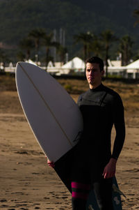 Portrait of young man standing on beach