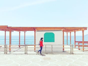 Man standing on beach against clear sky