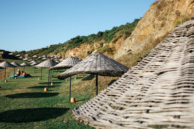 Scenic view of umbrellas against clear sky