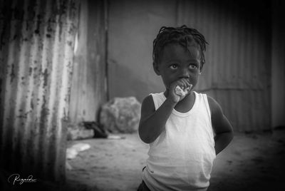 Portrait of smiling boy standing at home