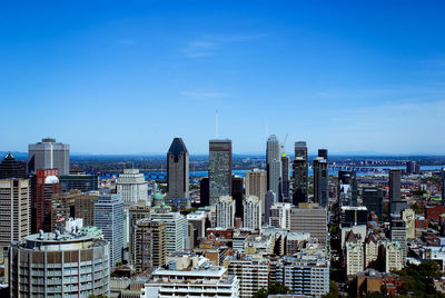 Aerial view of modern buildings in city against sky