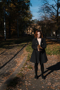 Full length of woman standing on railroad track