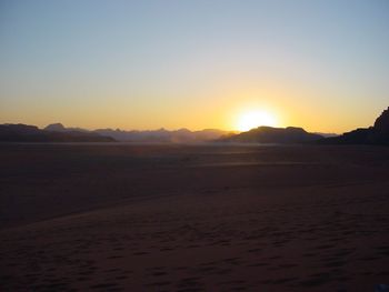 Scenic view of beach against sky during sunset