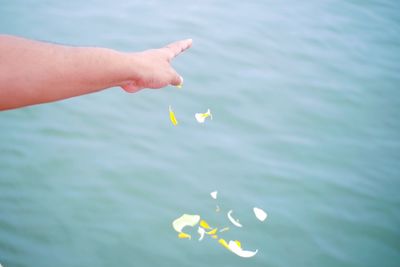 Cropped image of person floating on sea