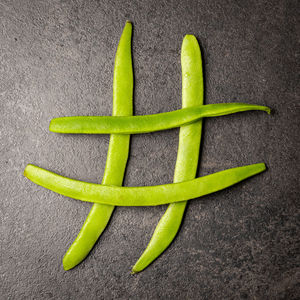 High angle view of green chili pepper over white background